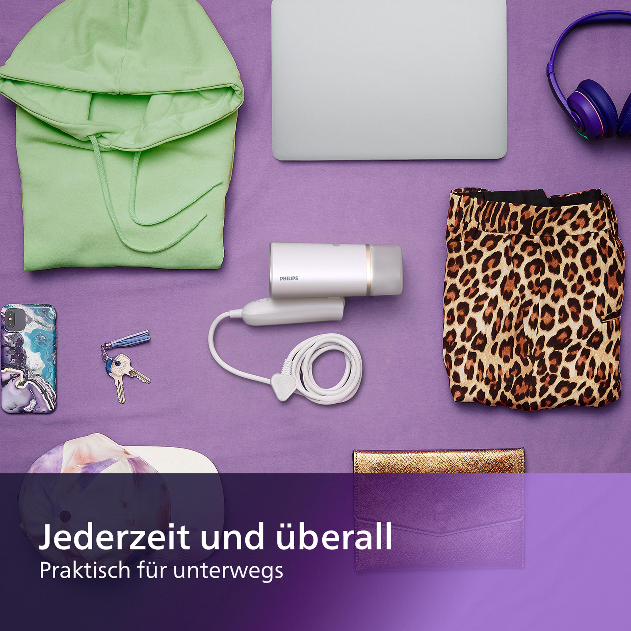 Verschiedene Gegenstände: Laptop, Kopfhörer, Kleidung, Schlüssel, Geldbörse und ein Philips Steamer.
