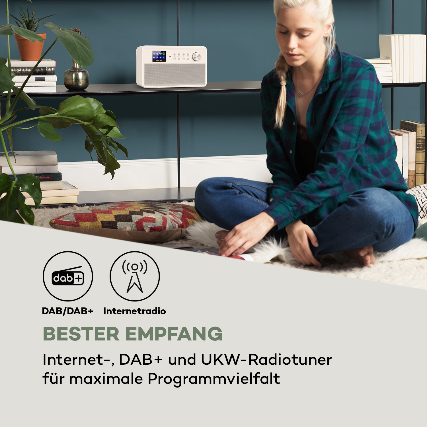 Frau sitzt neben Radio, DAB/DAB+ Internetradio, Bester Empfang-Text. Das Radio ist weiß.