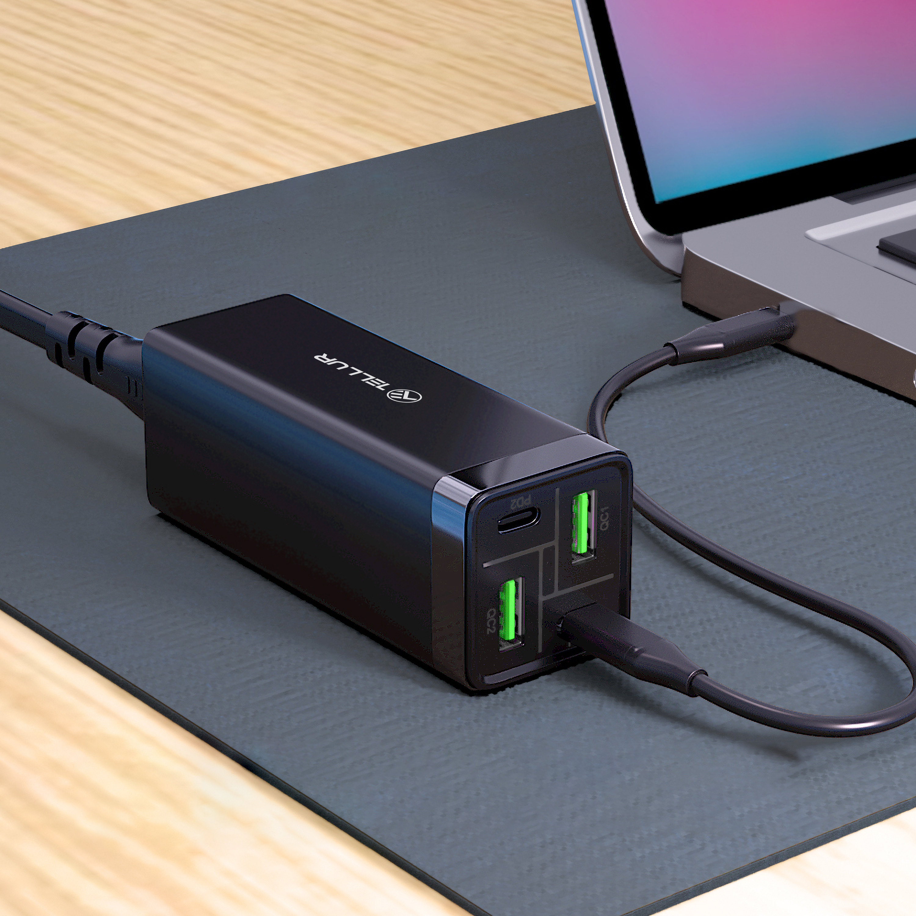 Czarna ładowarka z wieloma portami USB podłączona do laptopa.