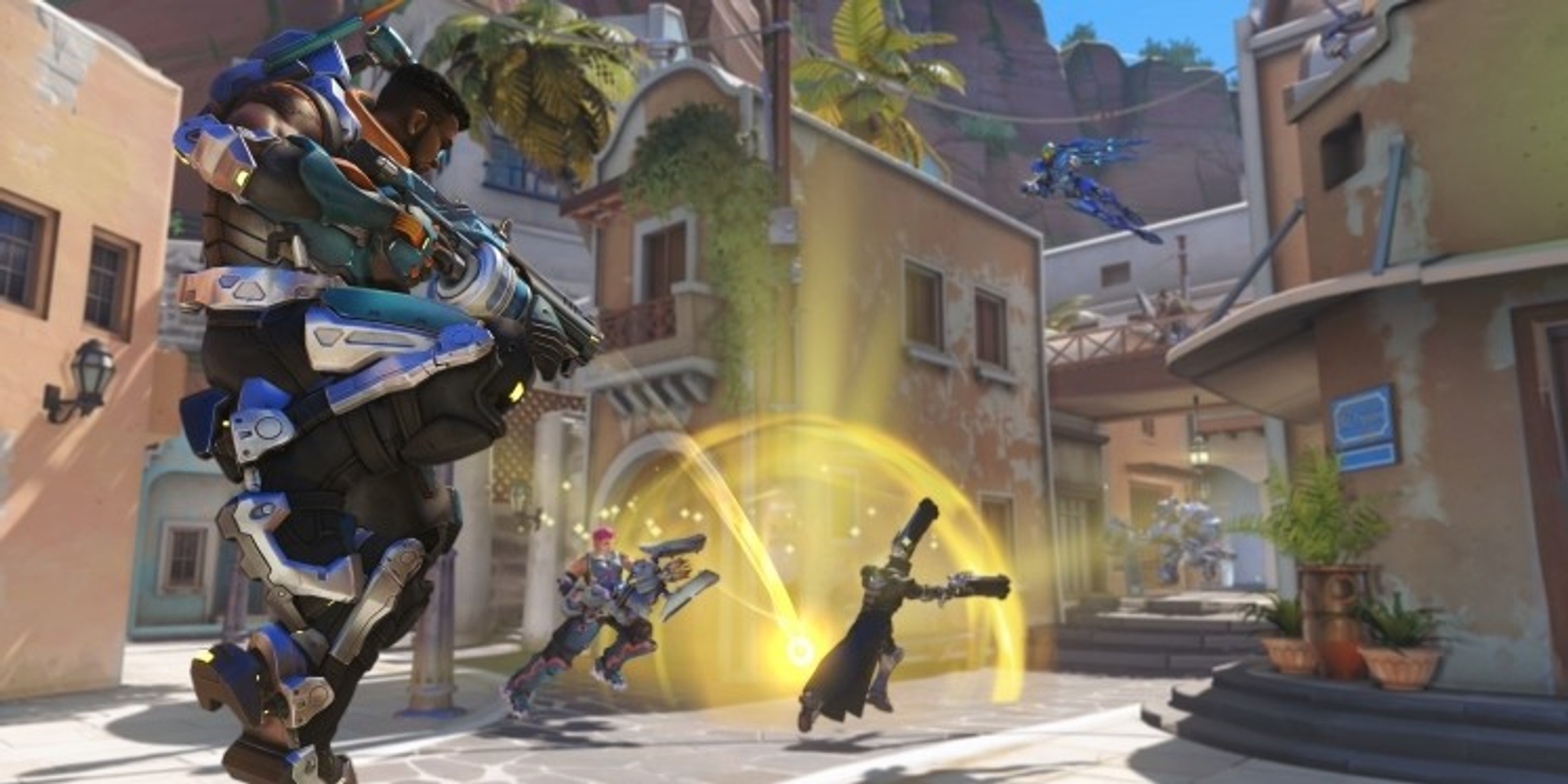 Scena z gry Overwatch: postacie walczą w kolorowym mieście.