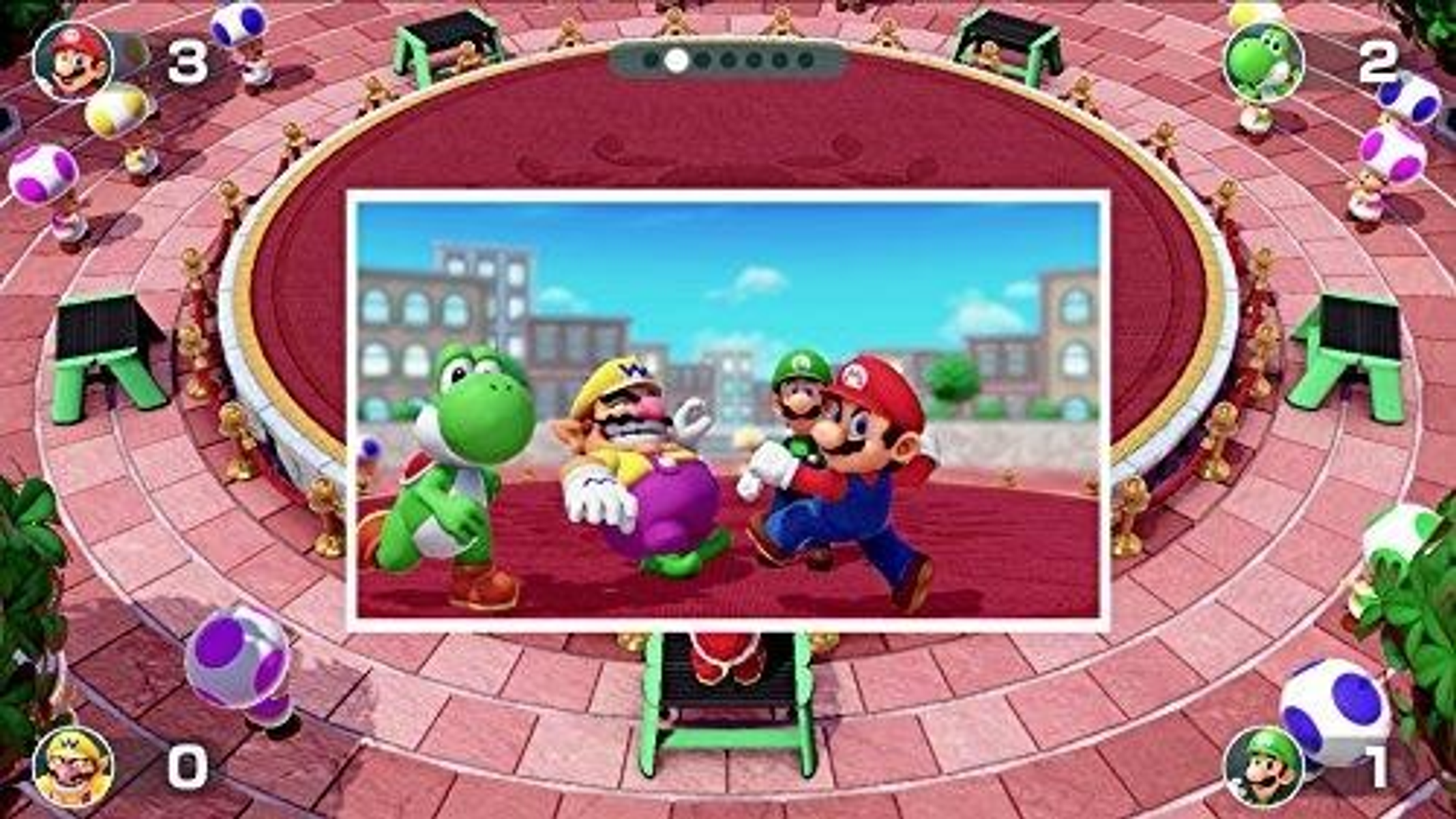 Mario i inne postacie na arenie gry otoczone dekoracjami.