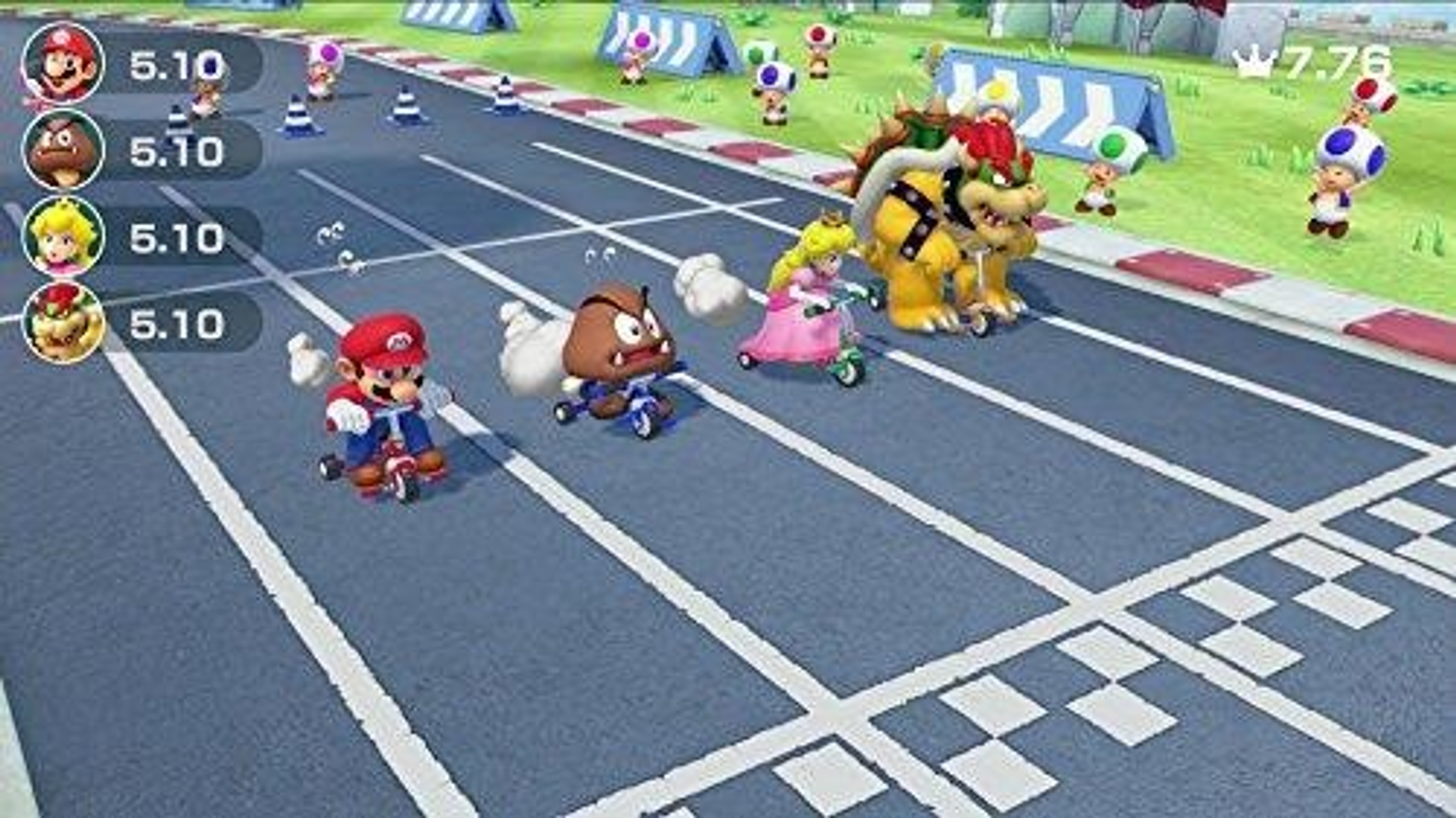 Scena z Mario Kart, wiele postaci na gokartach ściga się na torze. Widoczni są Mario, Peach i Bowser.
