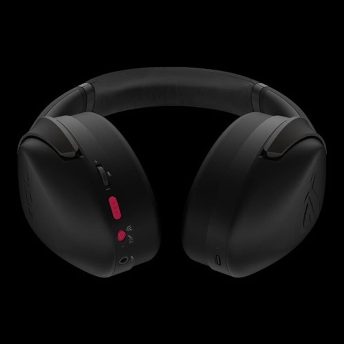 Czarny zestaw słuchawkowy z przyciskami i różowym przyciskiem. Tło jest całe czarne.