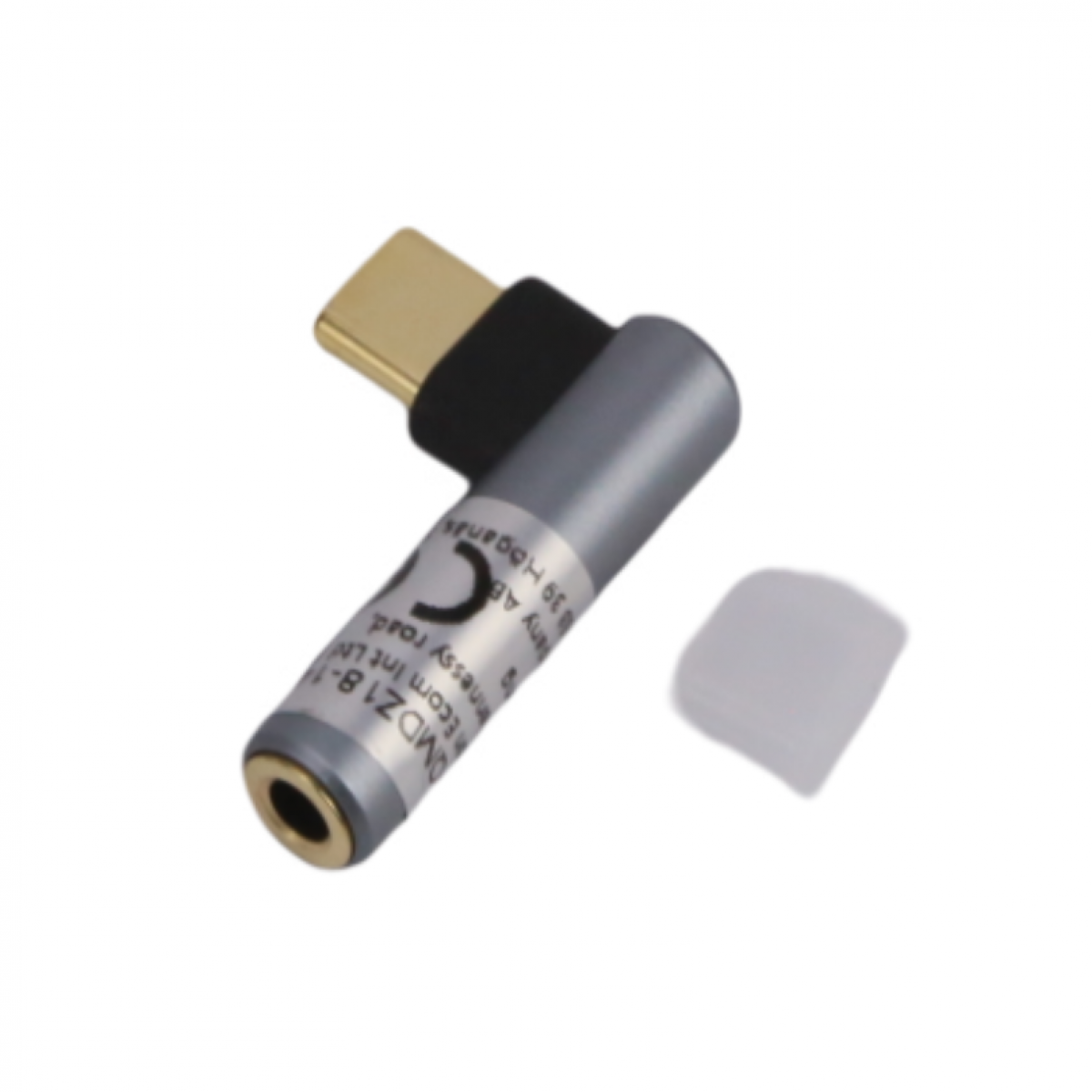 Zilveren en zwarte audio-adapter. Close-up tegen een witte achtergrond.