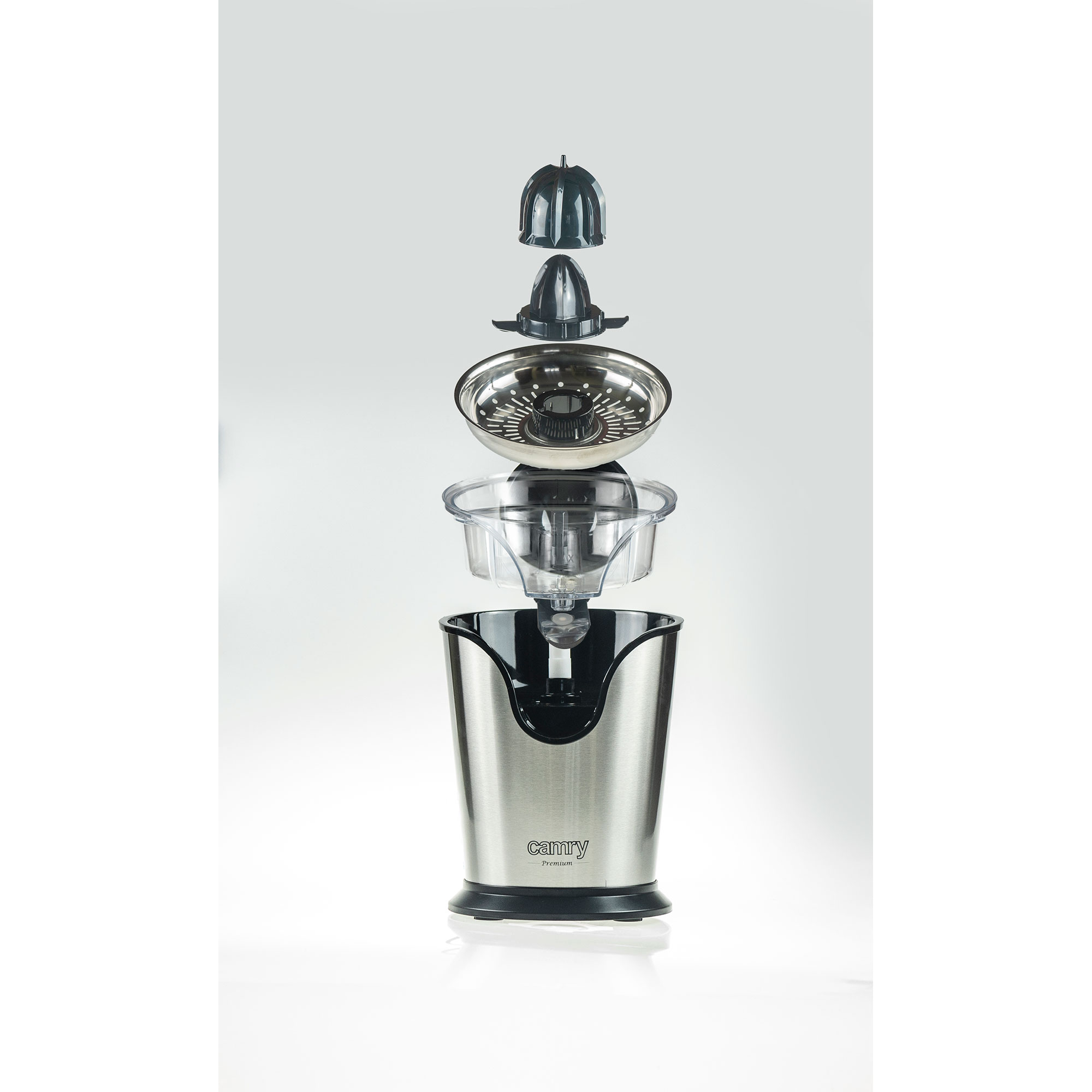 Rozebrana wyciskarka do cytrusów. Komponenty to pokrywa, wyciskarka, misa i podstawa.