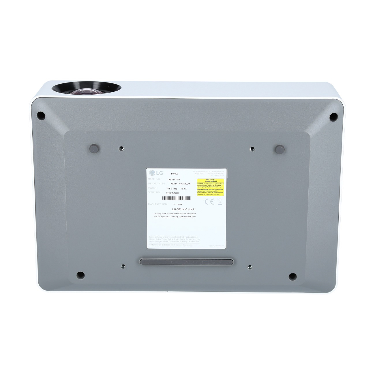 Projektor LG, biały z szarym spodem, widoczna spodnia strona, widoczne etykiety i porty.