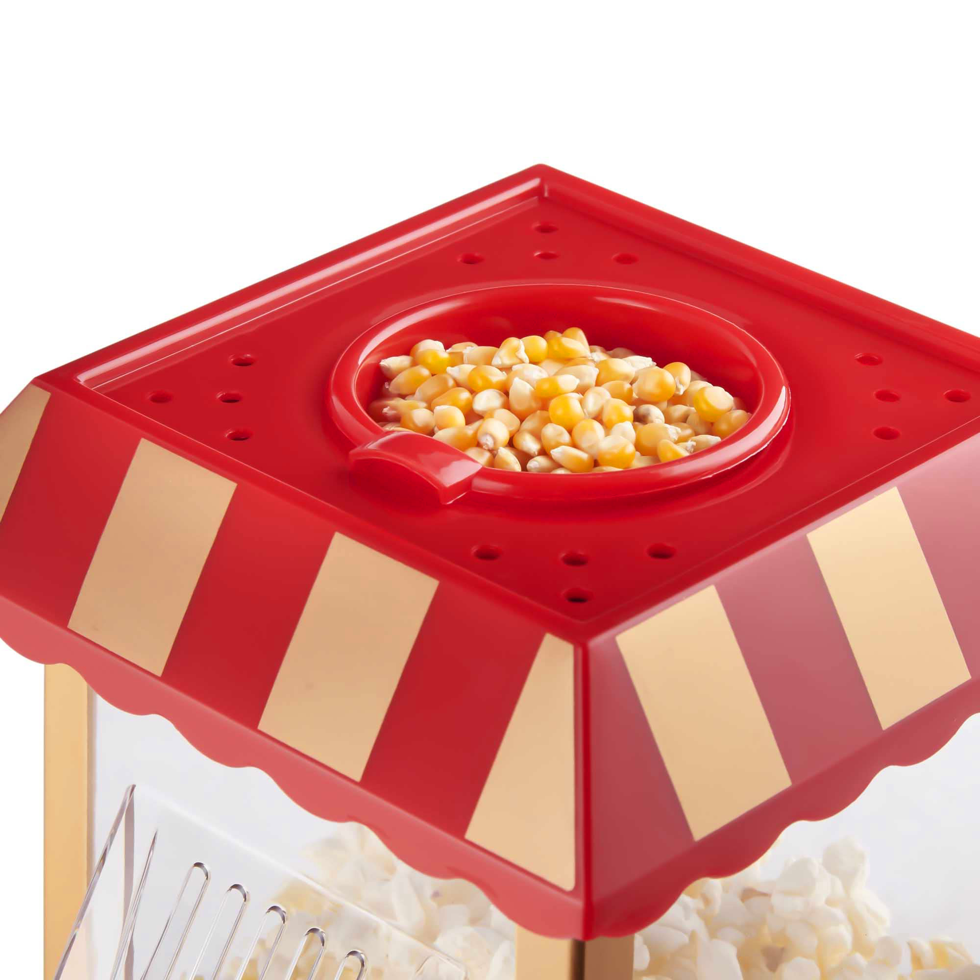 Parte superior de máquina de palomitas con granos dentro. Techo a rayas rojo y dorado, frente transparente.