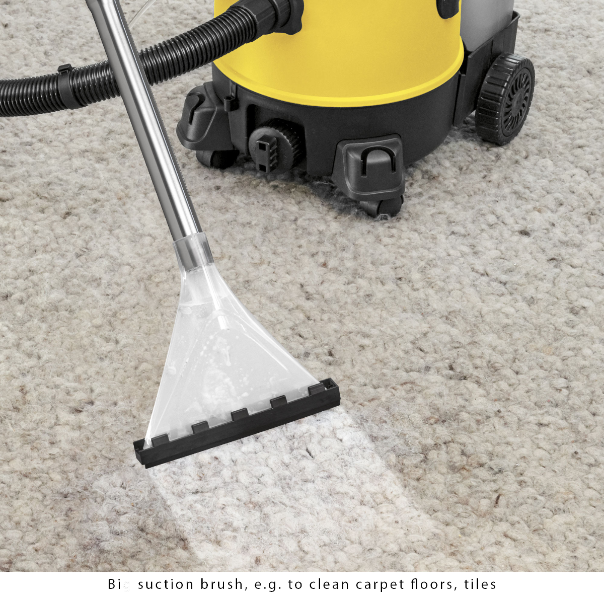 Odkurzacz do dywanów czyszczący dywan. Odkurzacz ma żółtą górę i czarny dół.