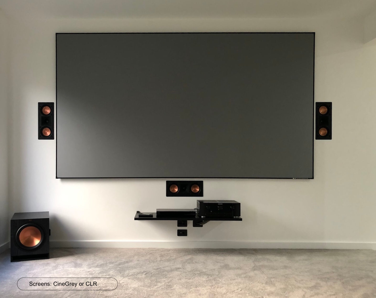 Ein Heimkino-Setup mit großem Bildschirm, Lautsprechern und Subwoofer.