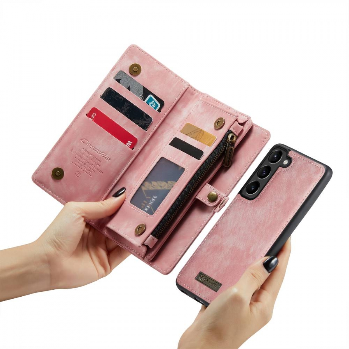 Geöffnete pinke Handyhülle-Geldbörse. Die Hülle enthält Karten, Reißverschlusstasche, Telefon.