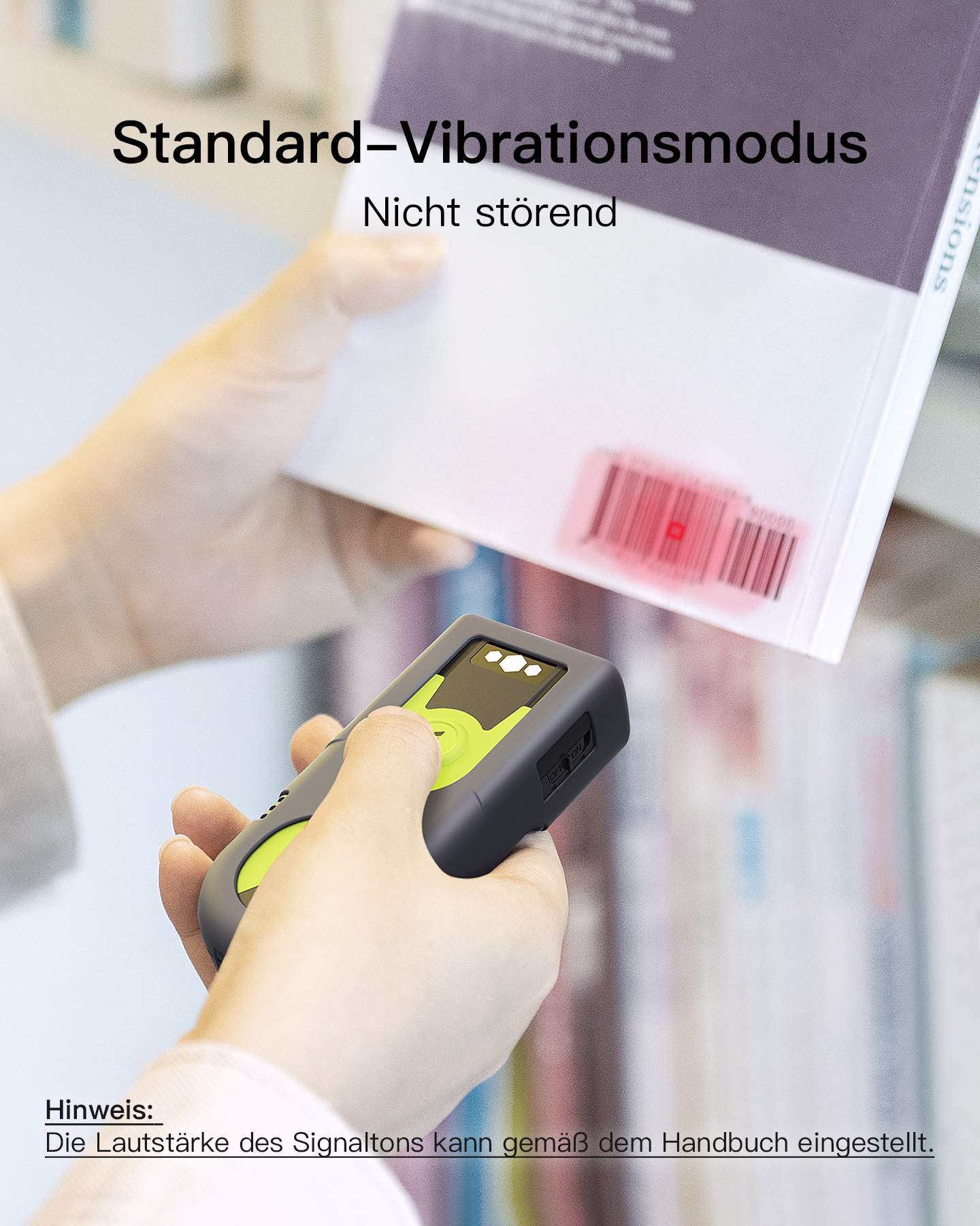 Ein Hand-Barcodescanner wird über ein Buch mit rotem Licht auf dem Barcode gehalten.