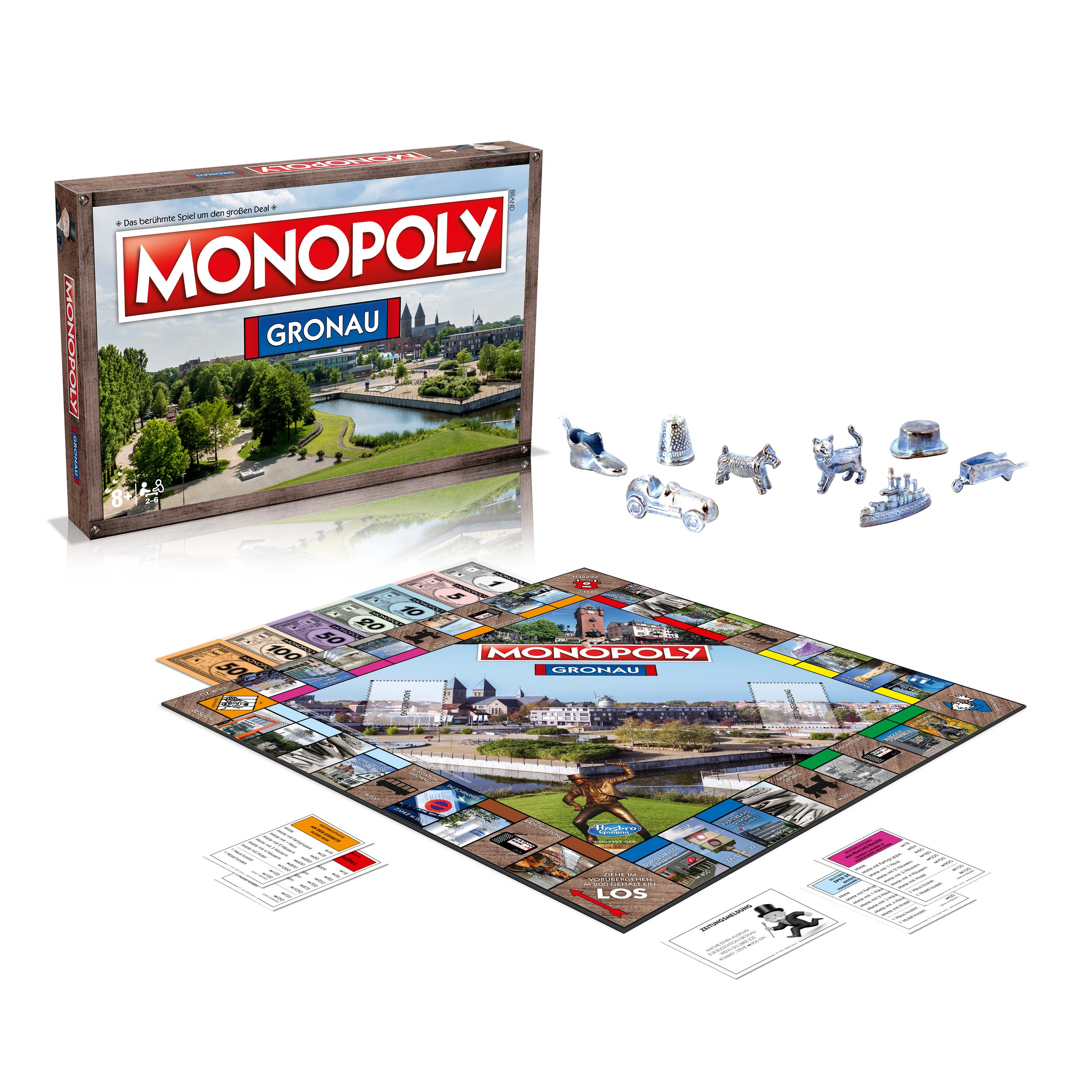 Monopoly-Brettspielbox und -Komponenten, einschließlich Spielbrett, Spielsteine und Karten, auf einer Oberfläche angeordnet.