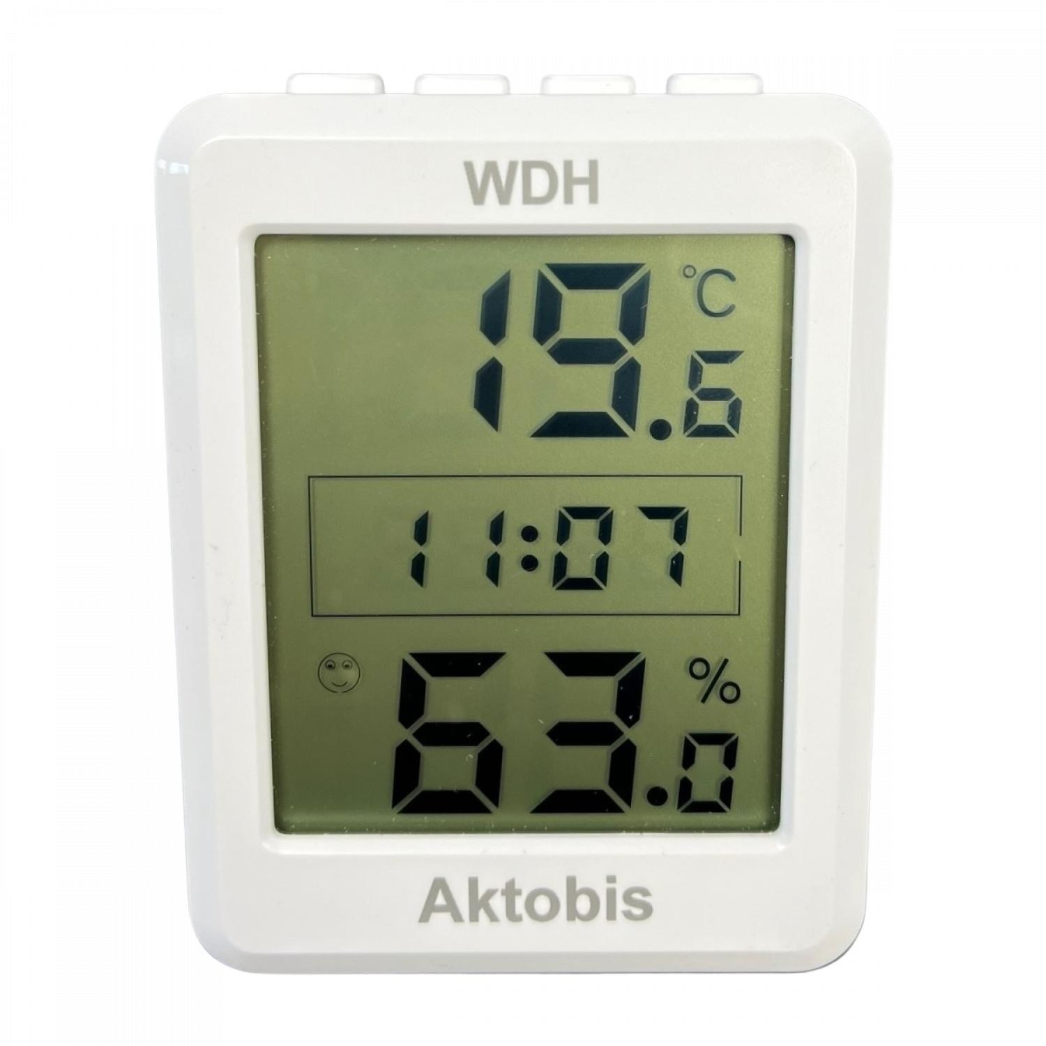 Ein weißes digitales WDH-Display zeigt 19,6°C, 11:07 und 63,0%. Das Display hat ein lächelndes Gesicht.