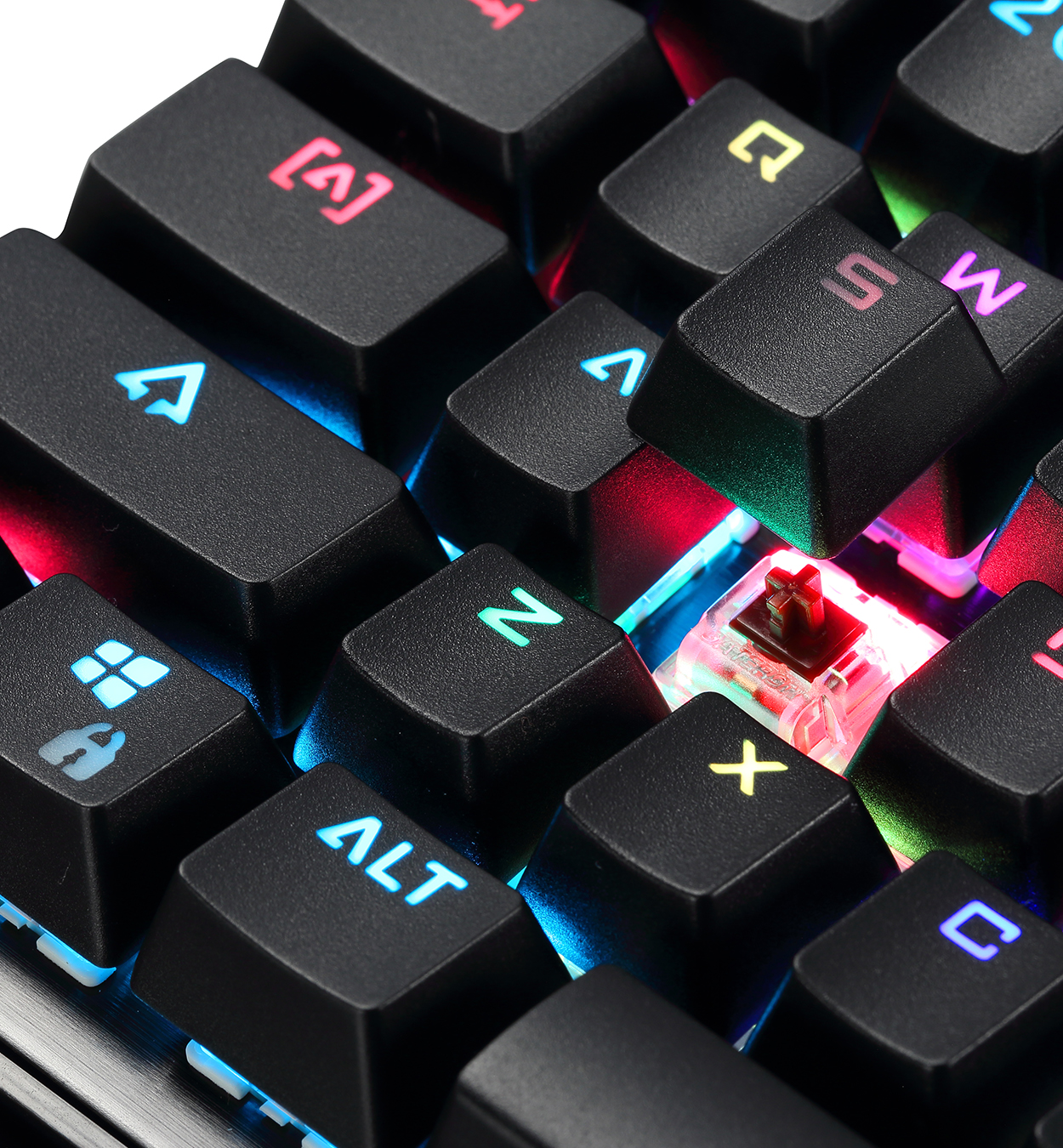 Primer plano de un teclado con tecla removida. El interruptor rojo es visible, con algunas teclas iluminadas.