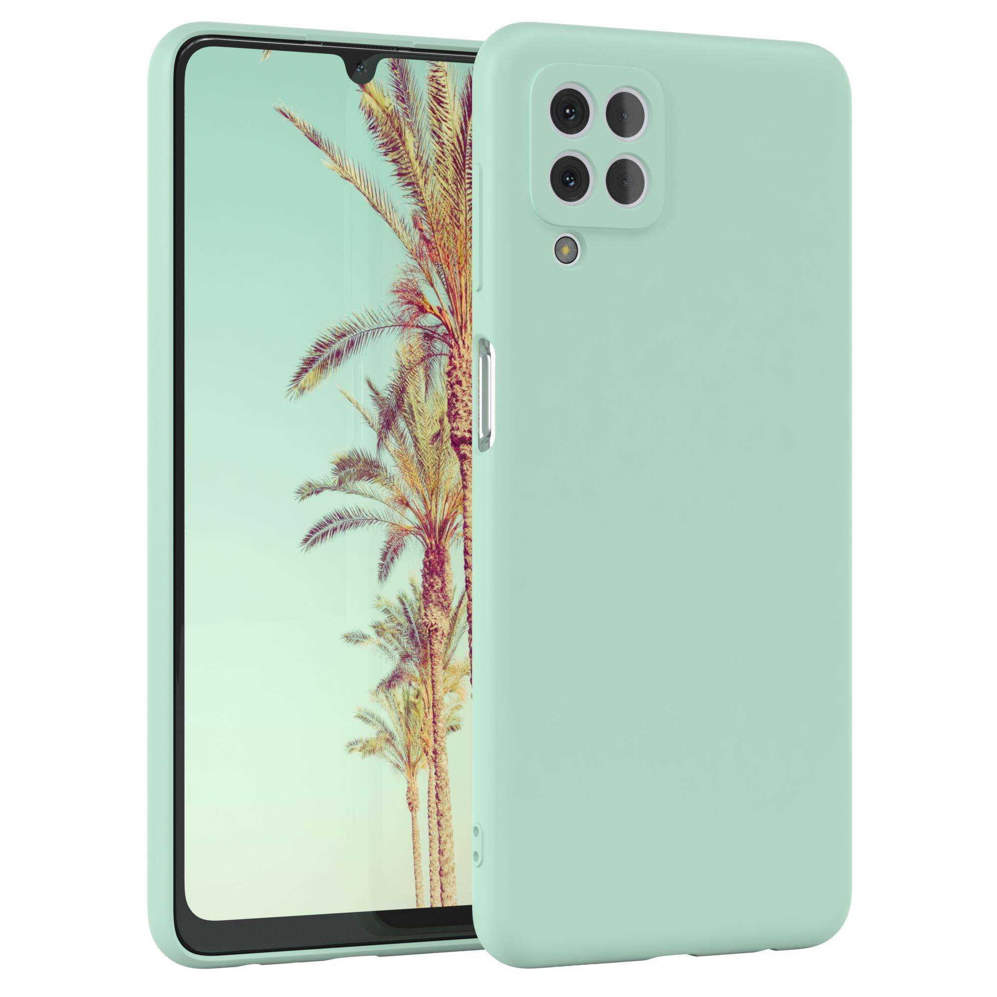 Mintgrünes Telefon in einer Hülle. Das Telefon zeigt eine tropische Landschaft.