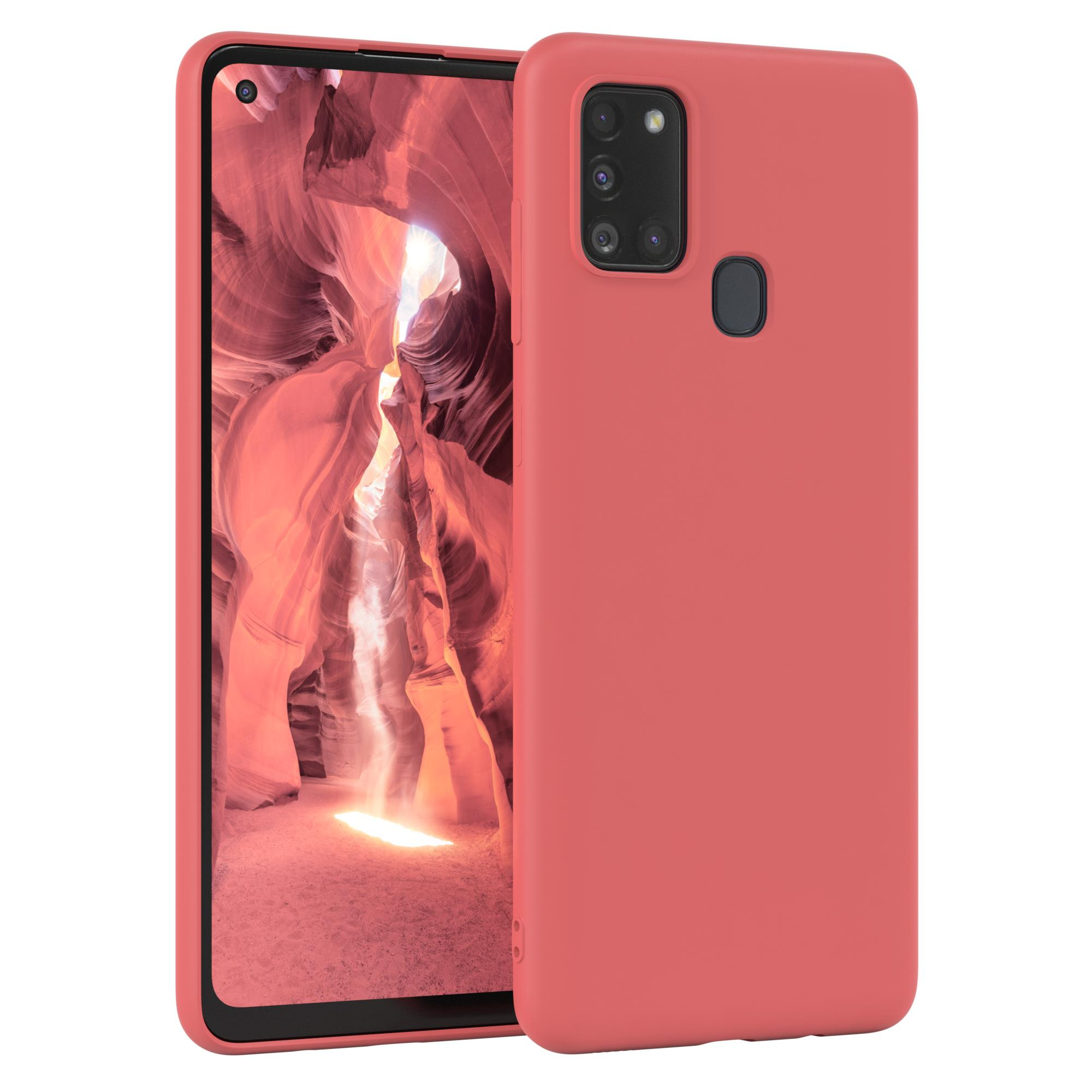 Korallfarbenes Telefon mit Hülle. Der Bildschirm zeigt einen Canyon.