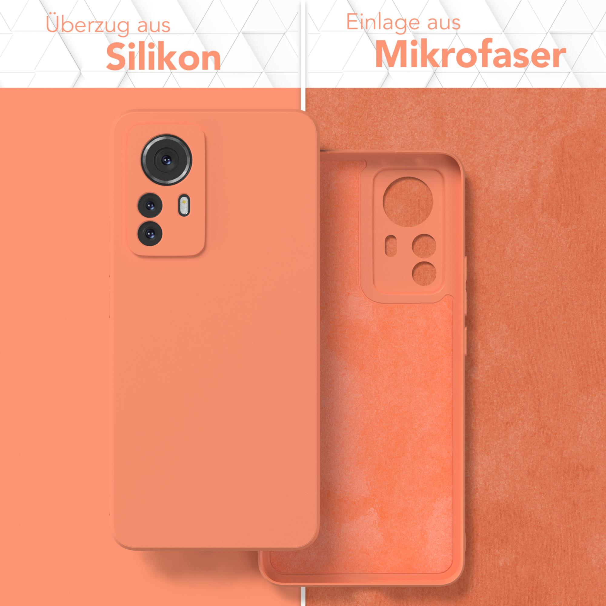 Orangene Handyhülle mit Silikonoberfläche und Mikrofaser-Innenraum. Telefon und Hülle sind abgebildet.