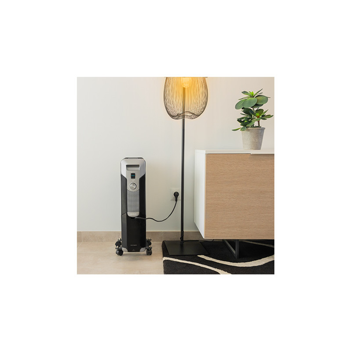 Czarno-srebrny grzejnik z lampą, szafką i ścianą w tle.