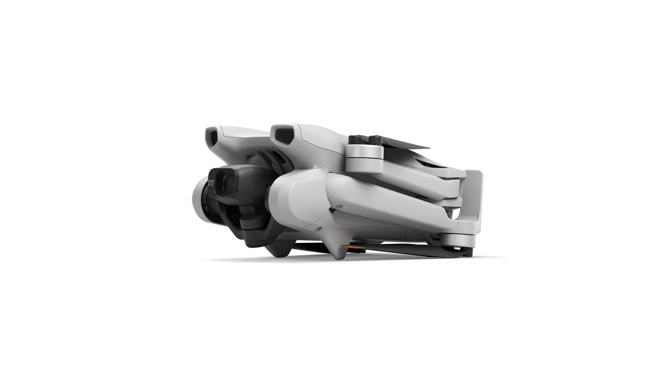 Biały dron ze złożonymi ramionami i kamerą na czarnym tle.