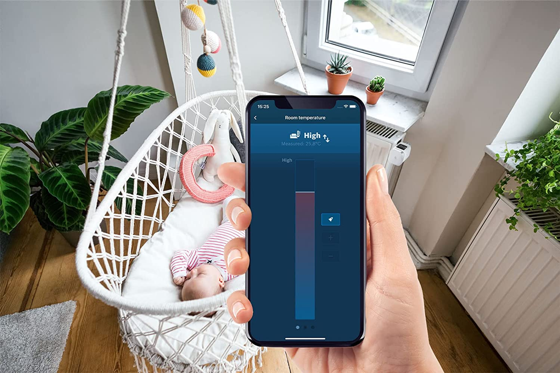 Eine Hand, die ein Telefon hält, das eine Smart-Home-App-Oberfläche anzeigt, mit einem Baby in einer Schaukel.