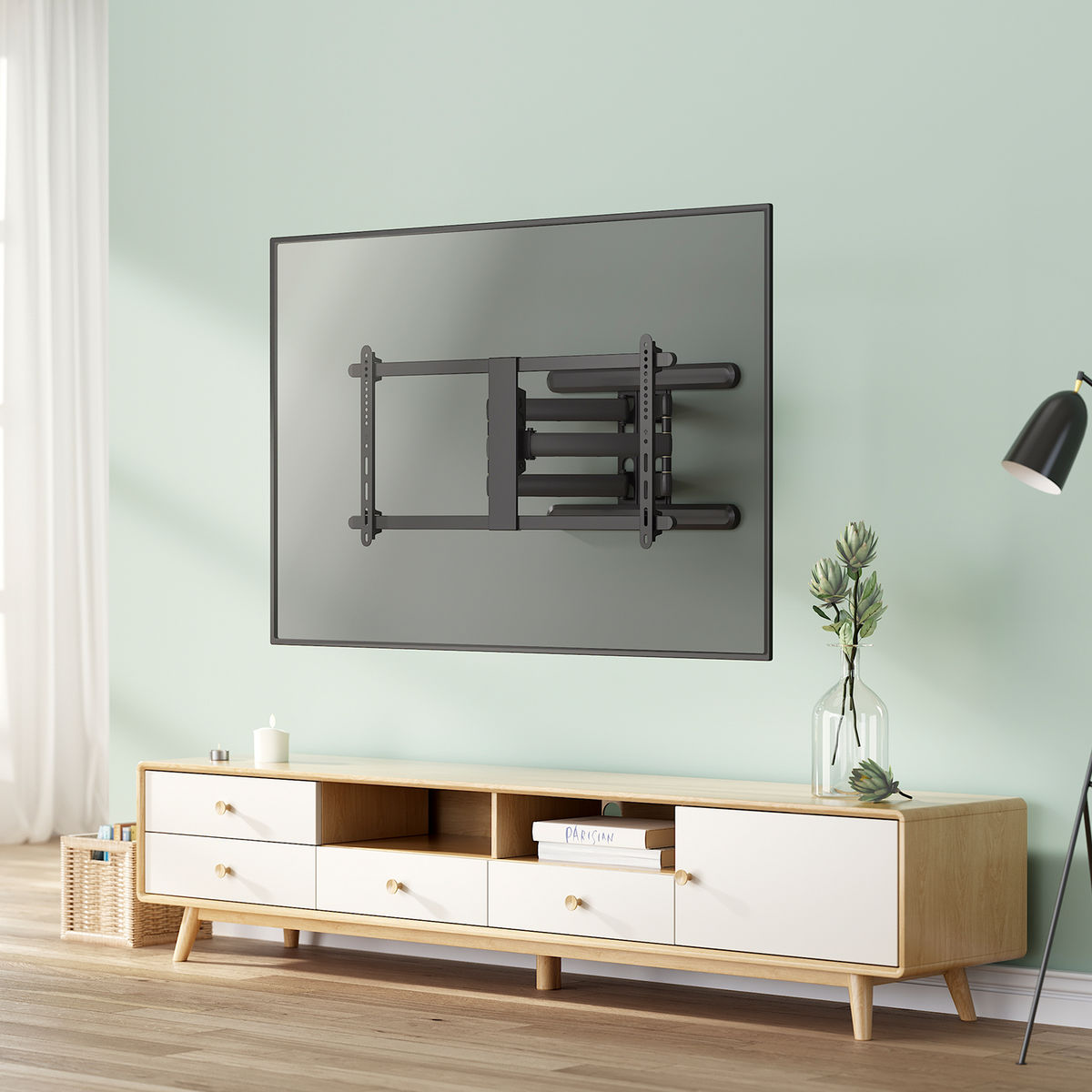 TV mounted on wall, black bracket, white and wood cabinet, light green wall.