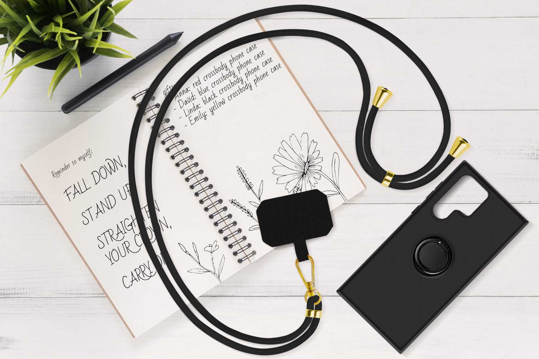 Notizblock, Stift, Handyhülle und Lanyard sind auf einer weißen Holzoberfläche angeordnet.