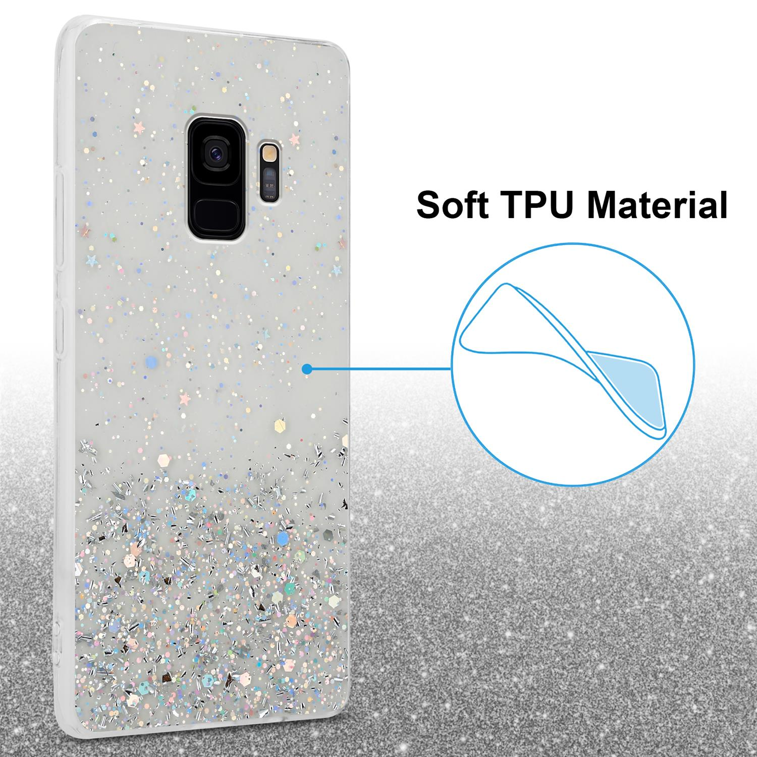 Handyhülle mit Glitzer und Sternen. Ein Telefon befindet sich in der Hülle. Die Hülle befindet sich auf einer glitzernden Oberfläche.