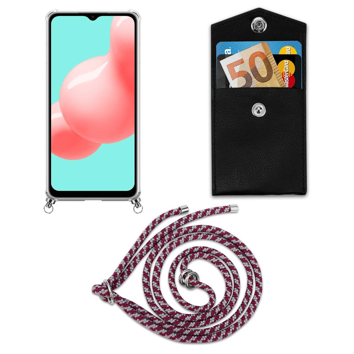 Smartphone mit klarer Hülle und Lanyard. Außerdem eine schwarze Lederhülle mit Karten und einem 50-Euro-Schein.