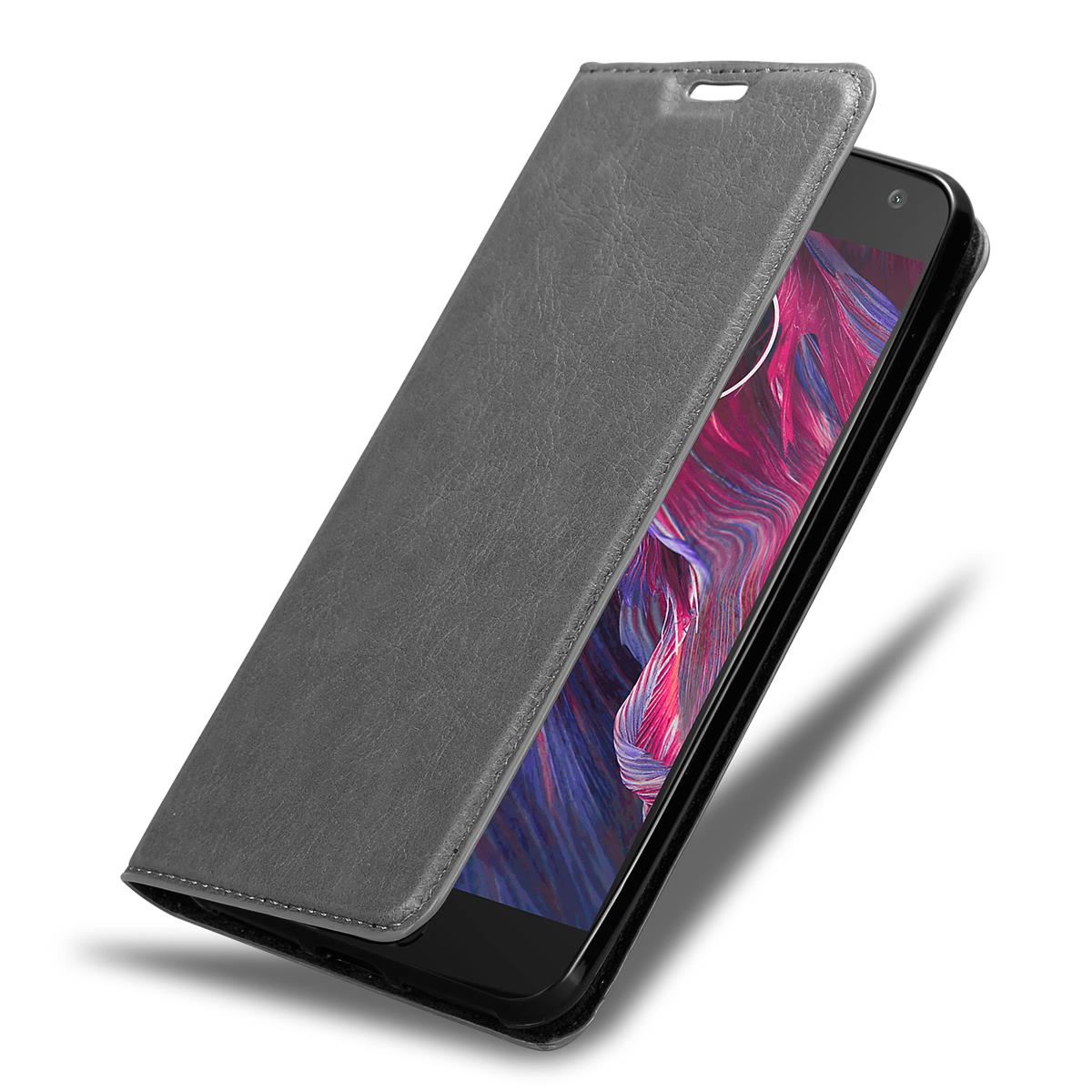 Graue Handyhülle, offen, bedeckt ein Telefon.