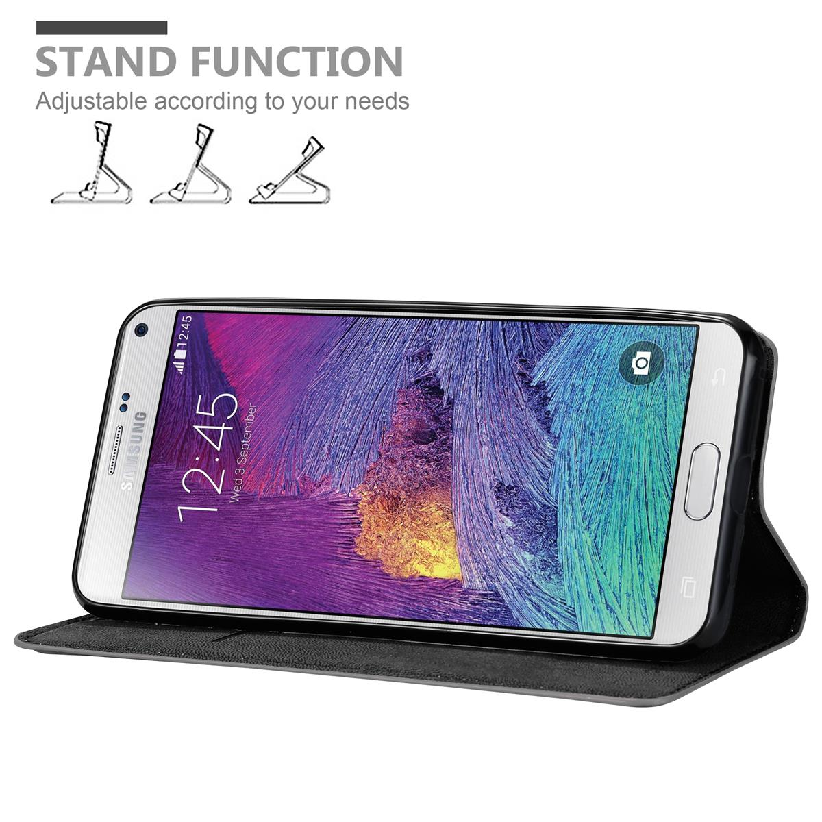 Weißes Telefon in einer schwarzen Hülle. Text und Illustrationen zur Standfunktion im Hintergrund.