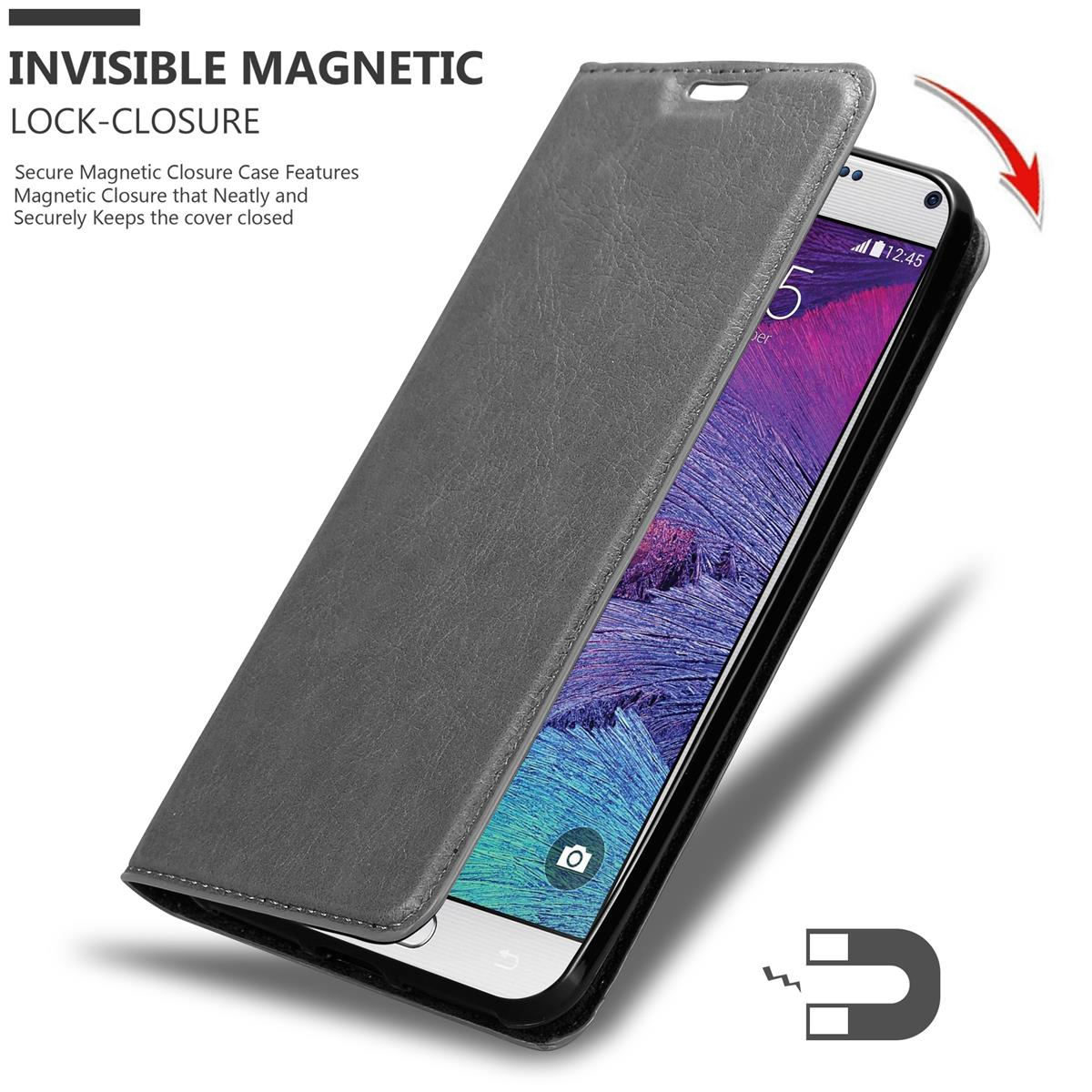 Graue Handyhülle geöffnet, ein Handy zeigend. Magnetverschluss hervorgehoben.