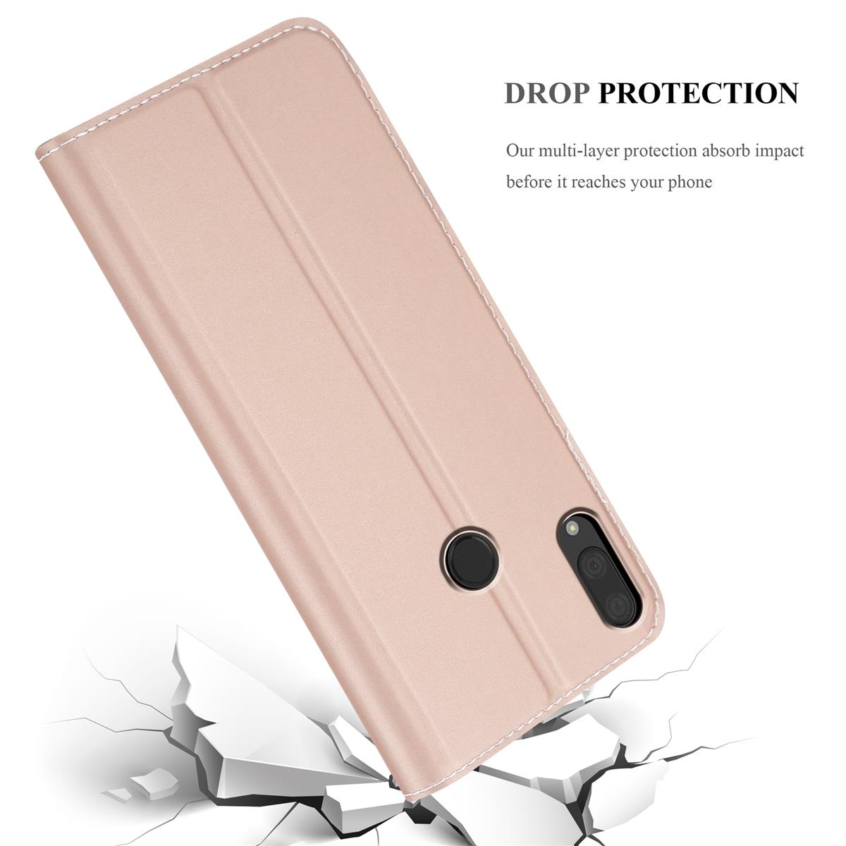 Custodia rosa per telefono, chiusa, con un telefono all'interno e una superficie incrinata sotto.