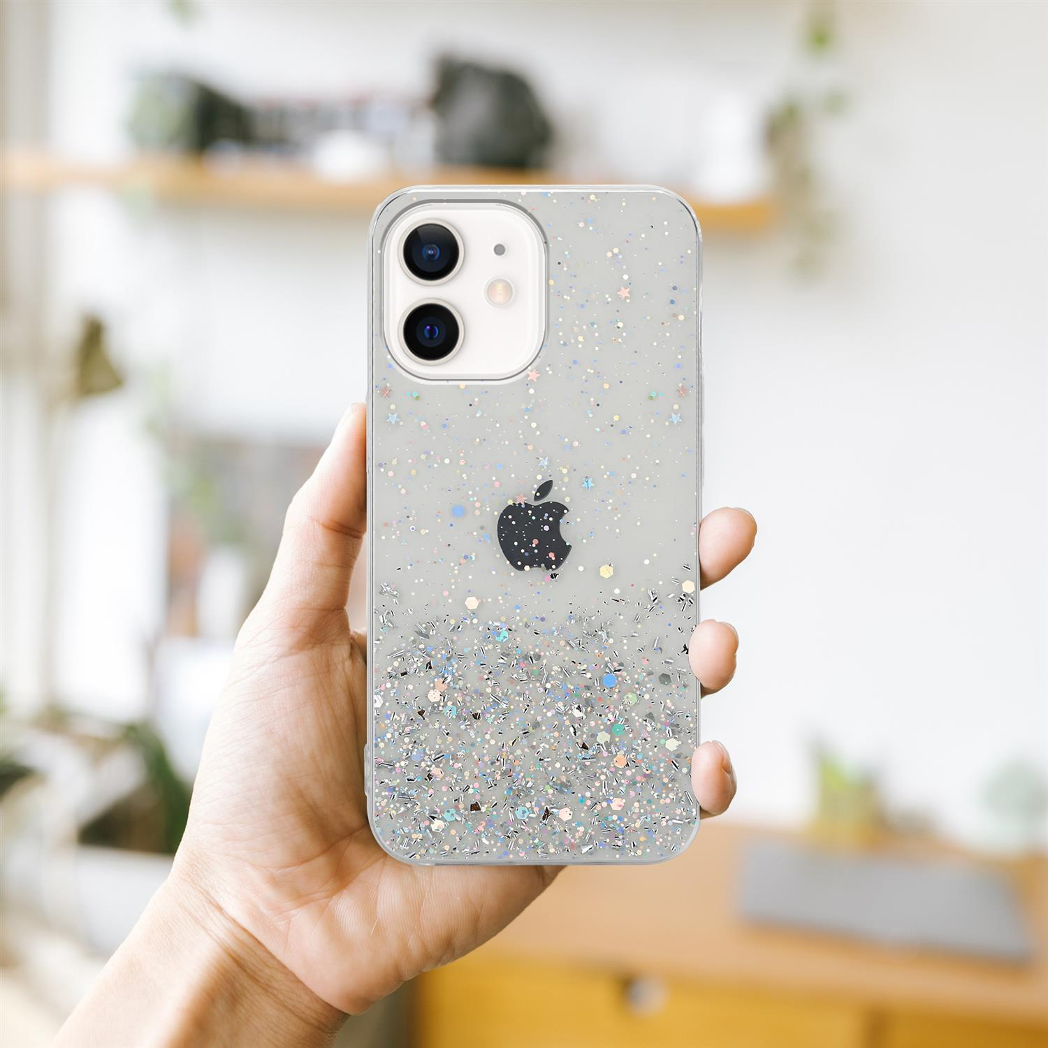 Hand hält transparente Handyhülle mit Glitzer. Apple-Logo sichtbar.