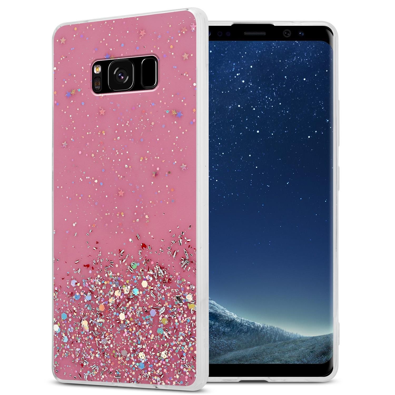 Rosa Handyhülle mit Glitzerdetail. Telefon ist in der Hülle. Weißer Hintergrund.