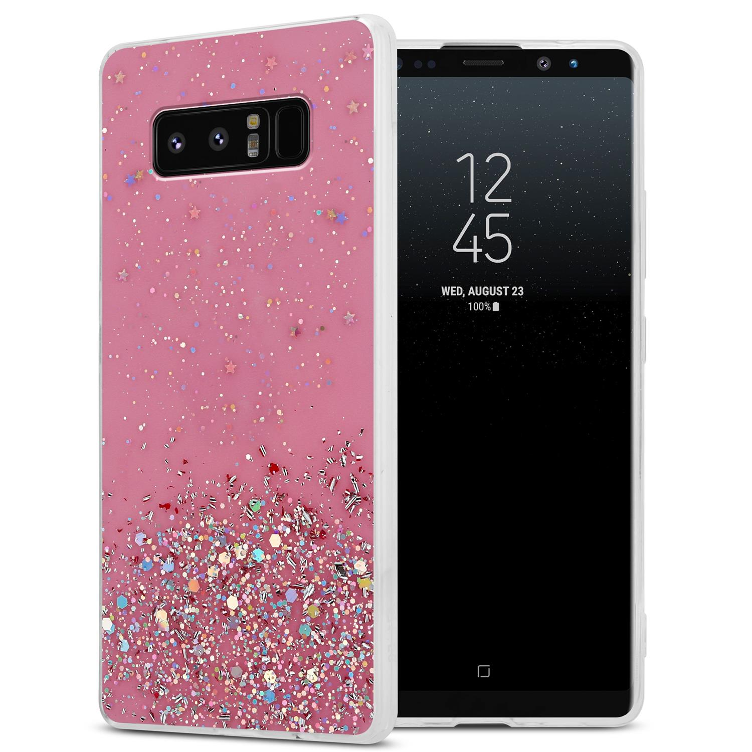 Rosa Handyhülle mit Glitzerdetail. Telefon ist in der Hülle. Weißer Hintergrund.