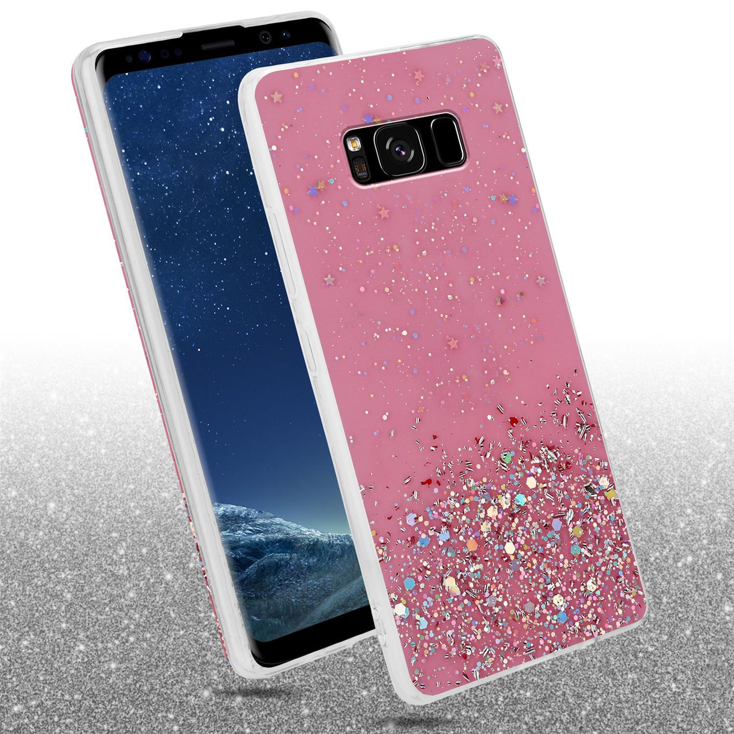 Rosa Handyhülle mit Glitzerdesign über einem Telefon. Der Hintergrund ist eine glitzernde Oberfläche.