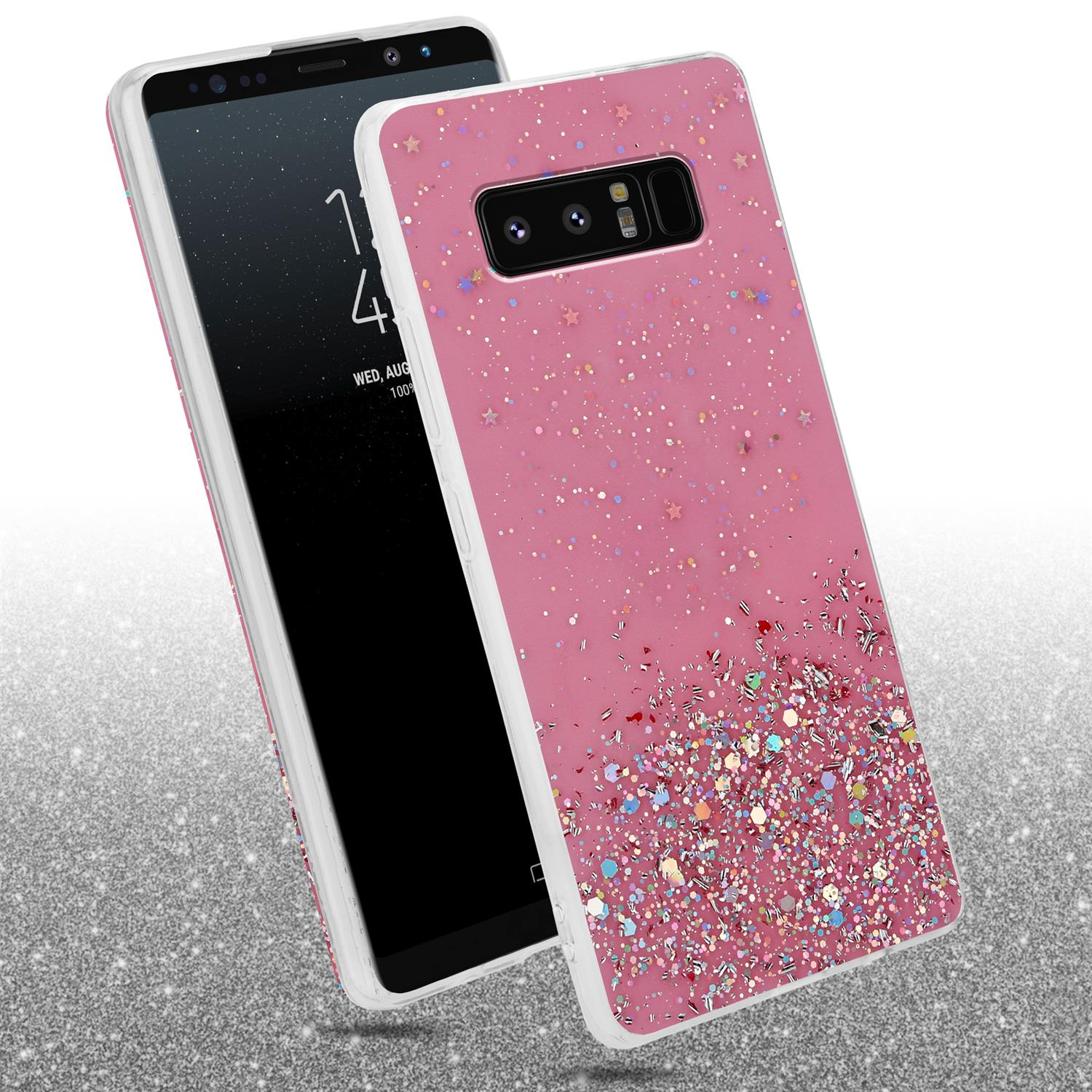 Rosa Handyhülle mit Glitzer. Daneben ein Handy. Glitzernder Hintergrund.
