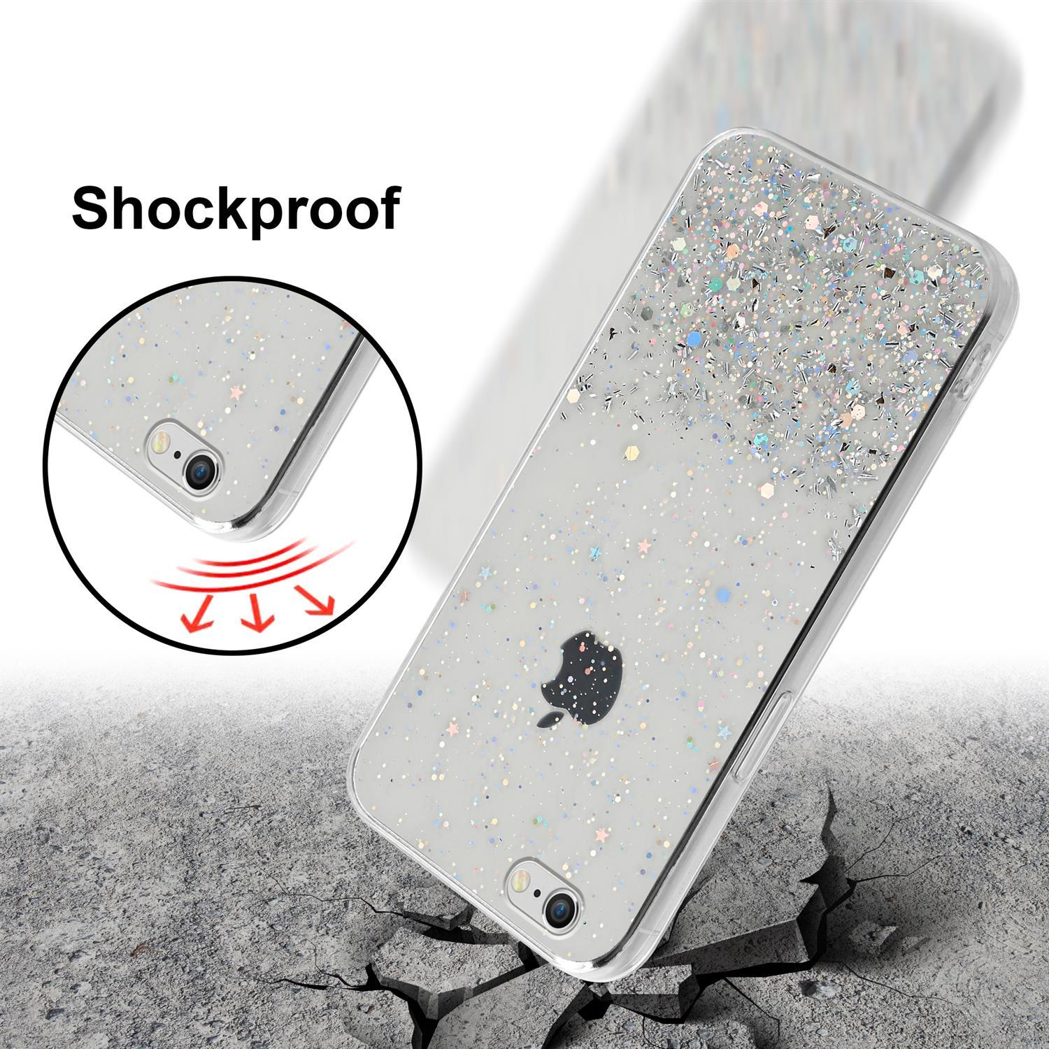 Eine transparente Handyhülle mit Glitzer und einem Telefon darin, auf einer rissigen Oberfläche. Das Wort "Stoßfest" ist sichtbar.