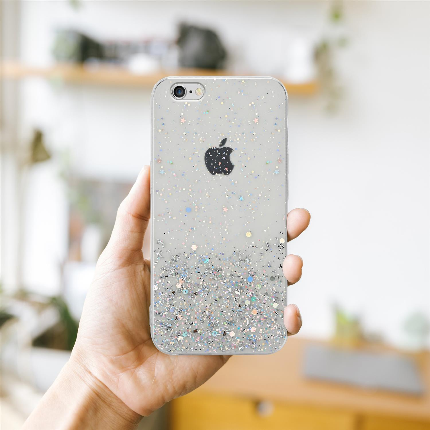 Hand hält Handyhülle mit Glitzer und Apfel-Logo.