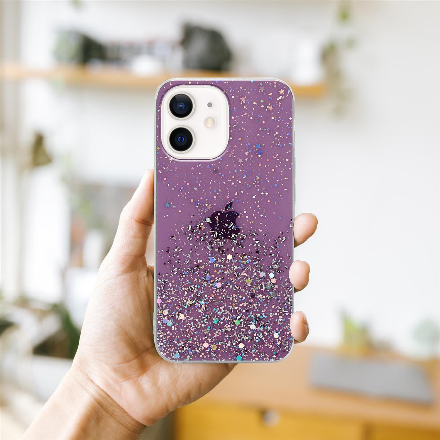 Hand hält eine lilafarbene Handyhülle mit Glitzer. Hintergrund ist ein Raum mit einem Holzregal.
