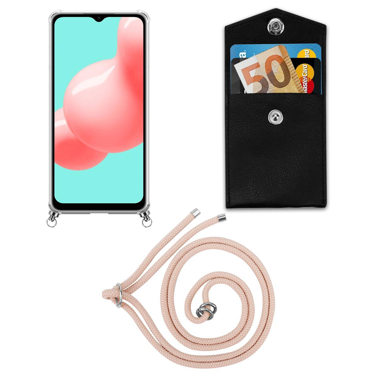 Telefon mit Hülle und rosa Kordel. Eine kleine schwarze Geldbörse mit Karten.