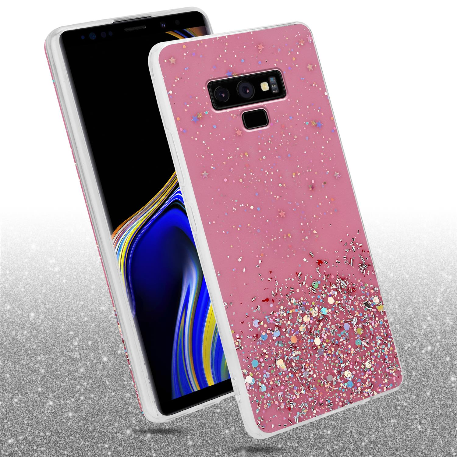 Rosa Handyhülle mit Glitzerdesign, auf glitzernder Oberfläche liegend.