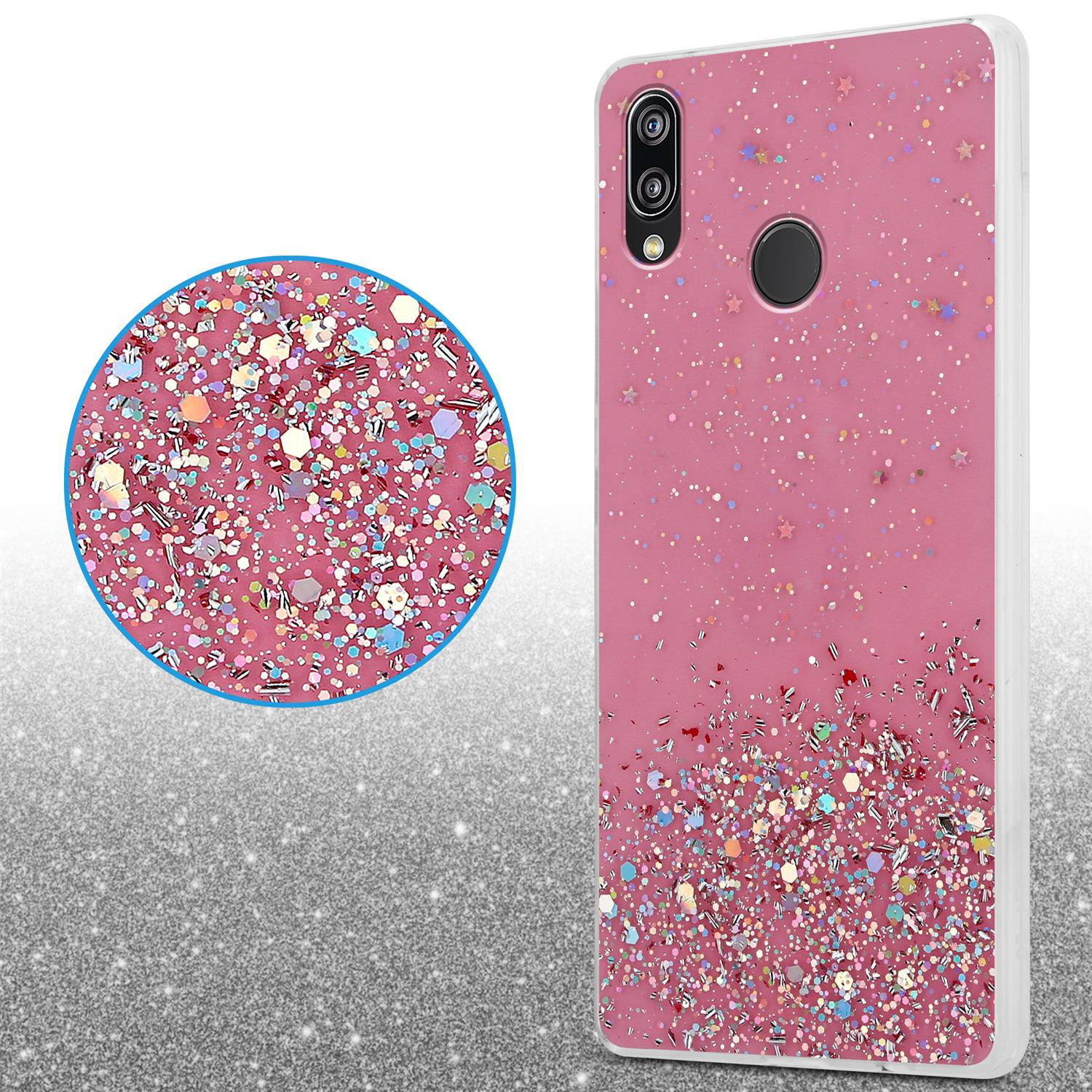 Rosa Handyhülle mit Glitzer. Eine Nahaufnahme zeigt Glitzer. Die Hülle liegt auf einer weißen Oberfläche.
