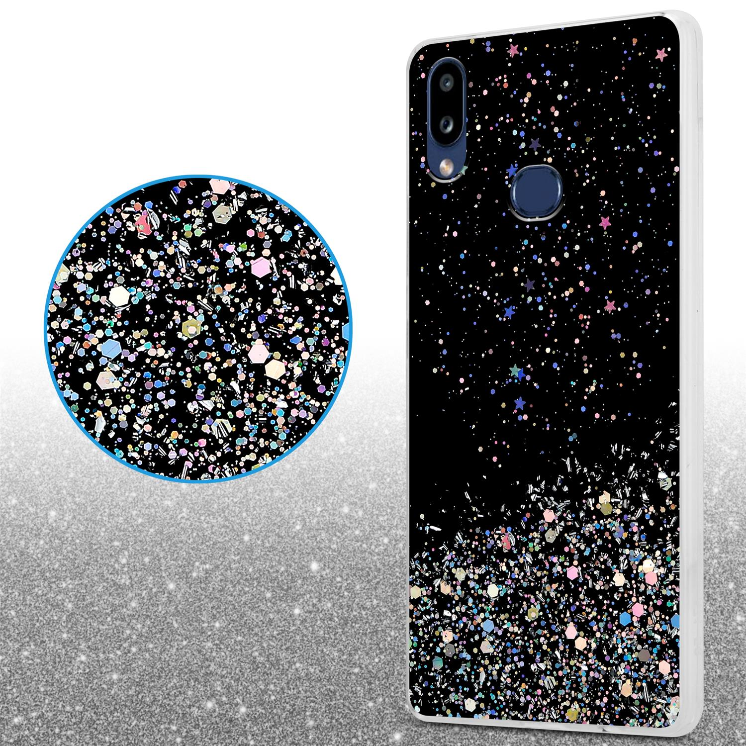 Schwarze Handyhülle mit Glitzer. Daneben ein Kreis mit Glitzer. Glitzernder Hintergrund.