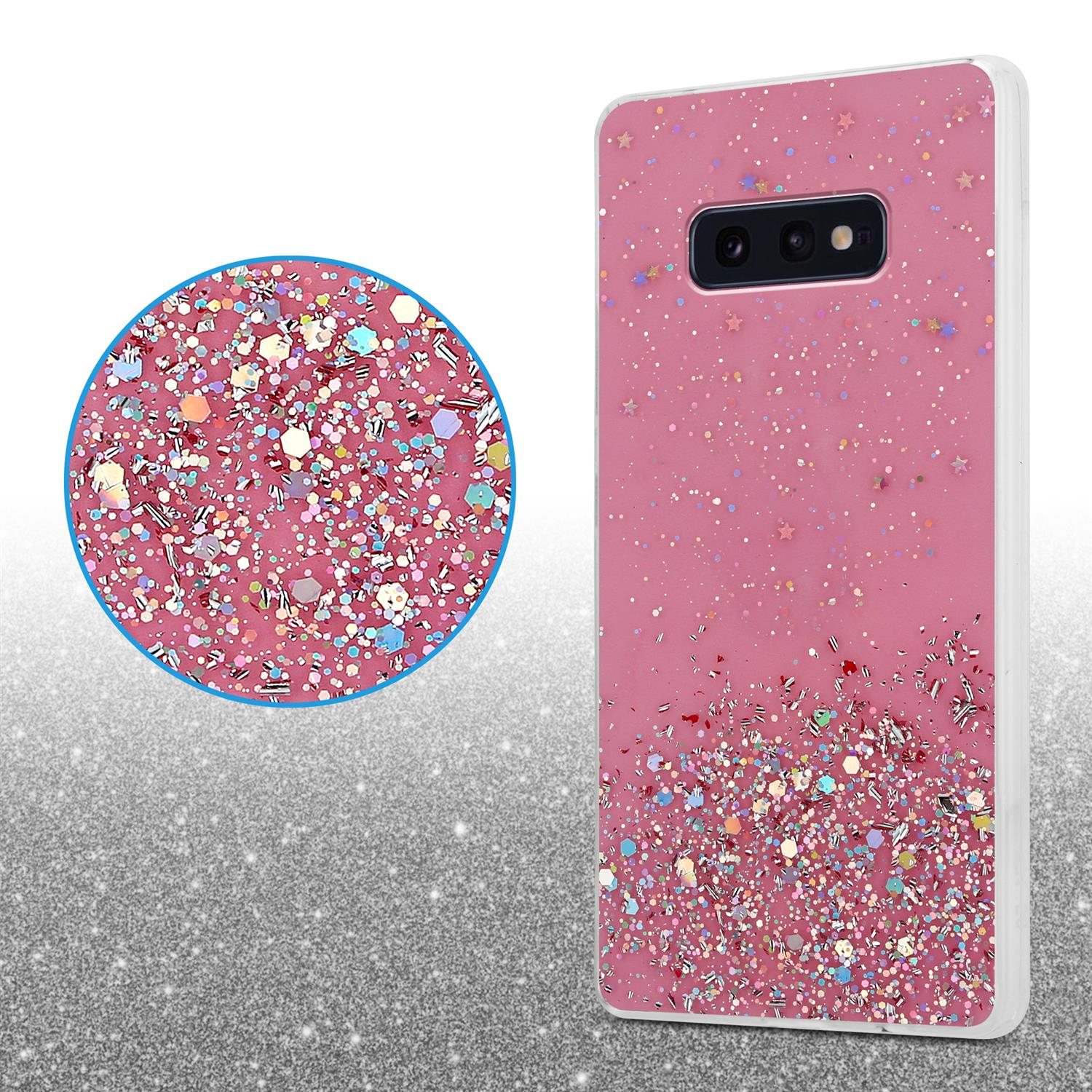 Custodia rosa per telefono con glitter e motivo a stelle. Un cerchio di glitter in primo piano nell'angolo.