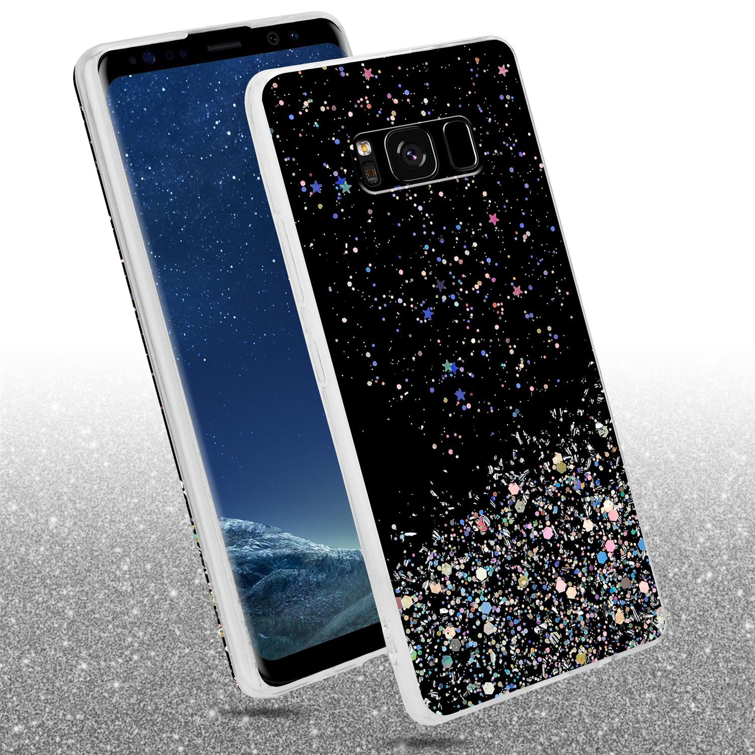 Schwarze Handyhülle mit Glitzer. Ein Telefon ist darin. Auf einer glitzernden Oberfläche.