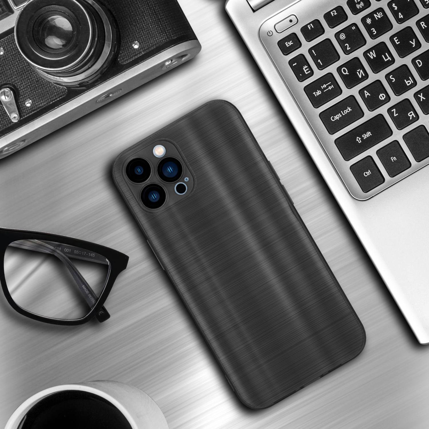 Handyhülle auf einem Schreibtisch. Brille, Laptop und Kamera sind ebenfalls auf dem Schreibtisch.