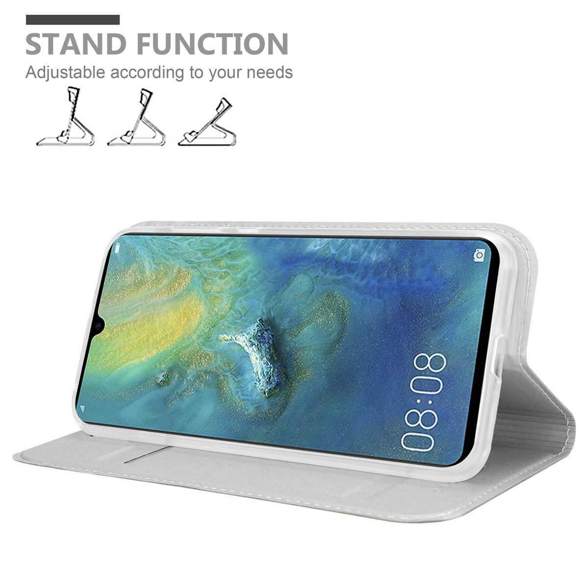Telefon auf einem Ständer, mit geöffnetem Etui. Der Bildschirm zeigt ein Landschaftsbild und die Zeit.