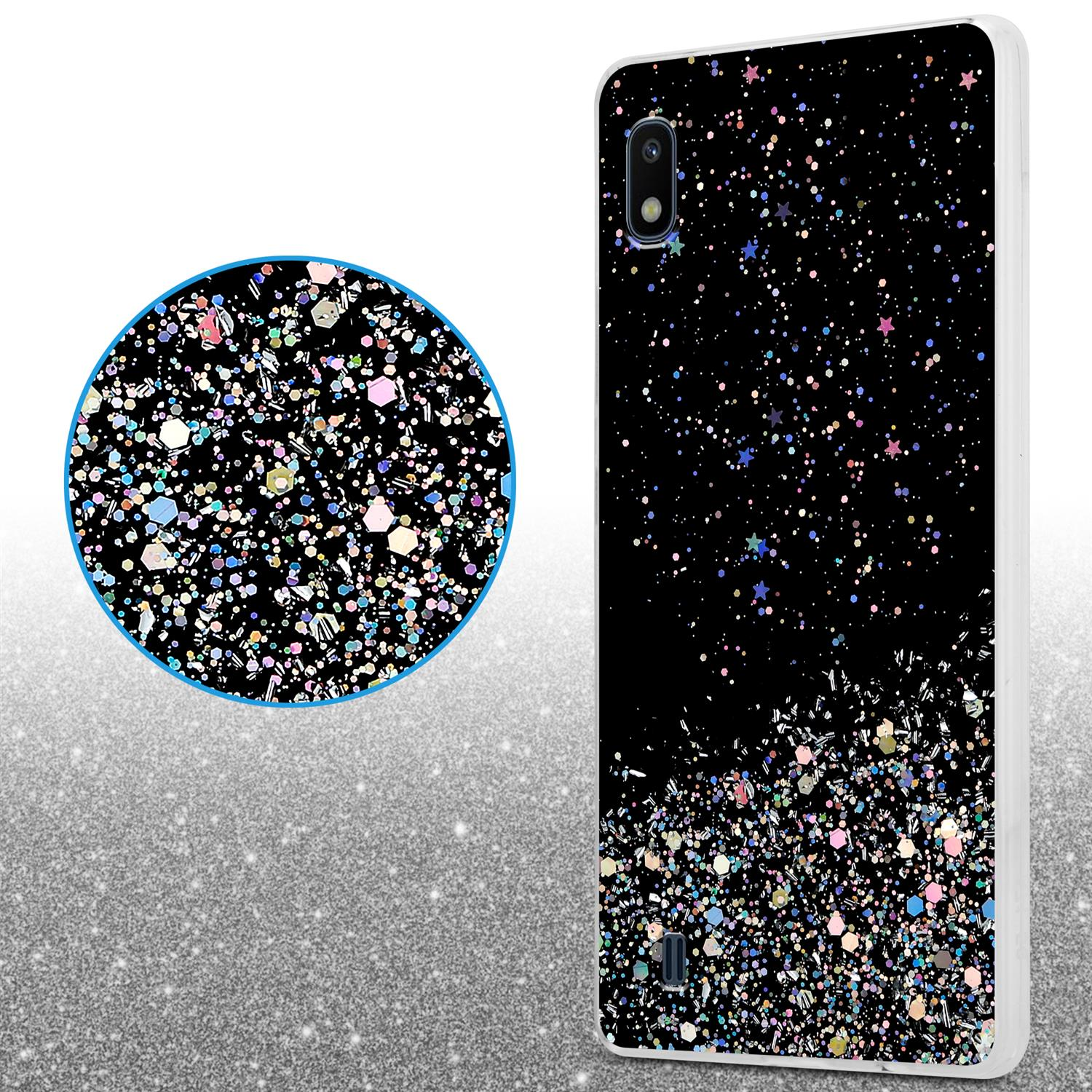 Schwarze Handyhülle mit Glitzereffekt, Nahaufnahme des Glitzers und verschwommener Silberhintergrund.