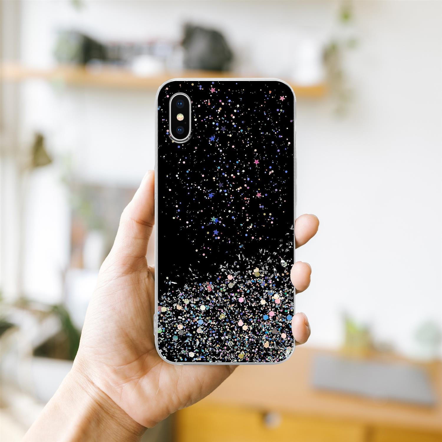 Hand hält schwarze Handyhülle mit Glitzer.